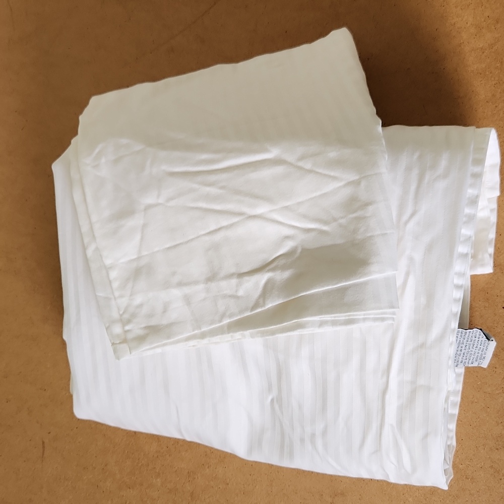 White flat sheet and pillow